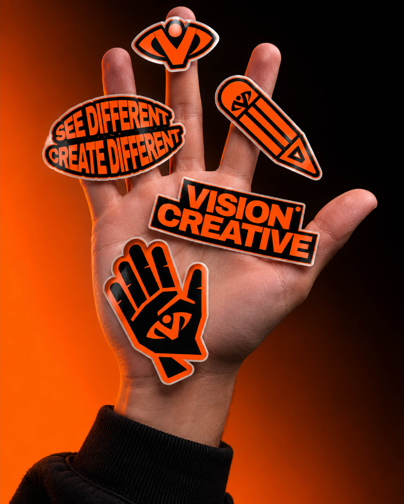 Vision Creative stickers held in a hand